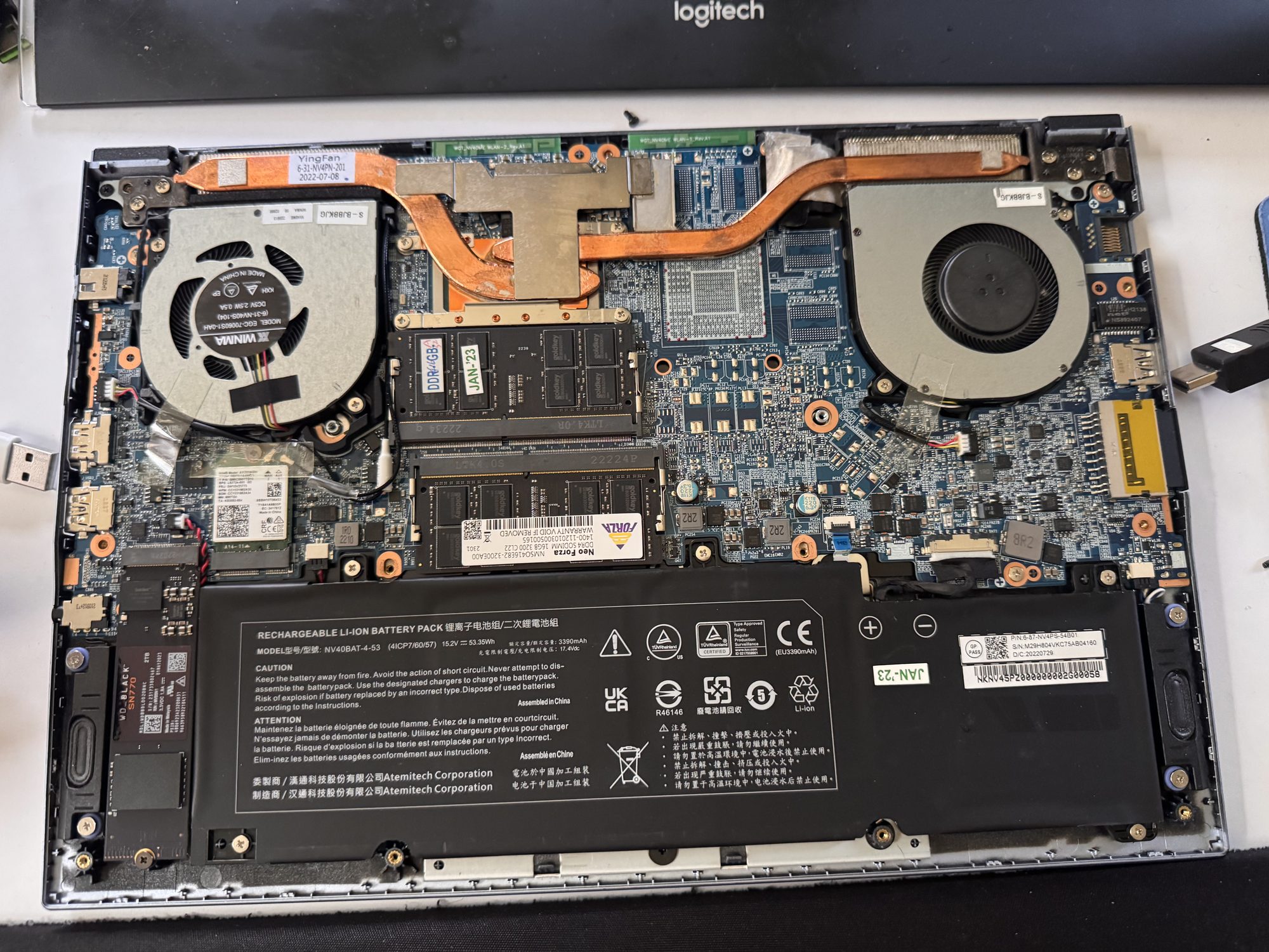 Open Galago Pro 6 laptop showing the full motherboard, with the heat sink and its copper heat pipes still attached, spanning both cooling fans.