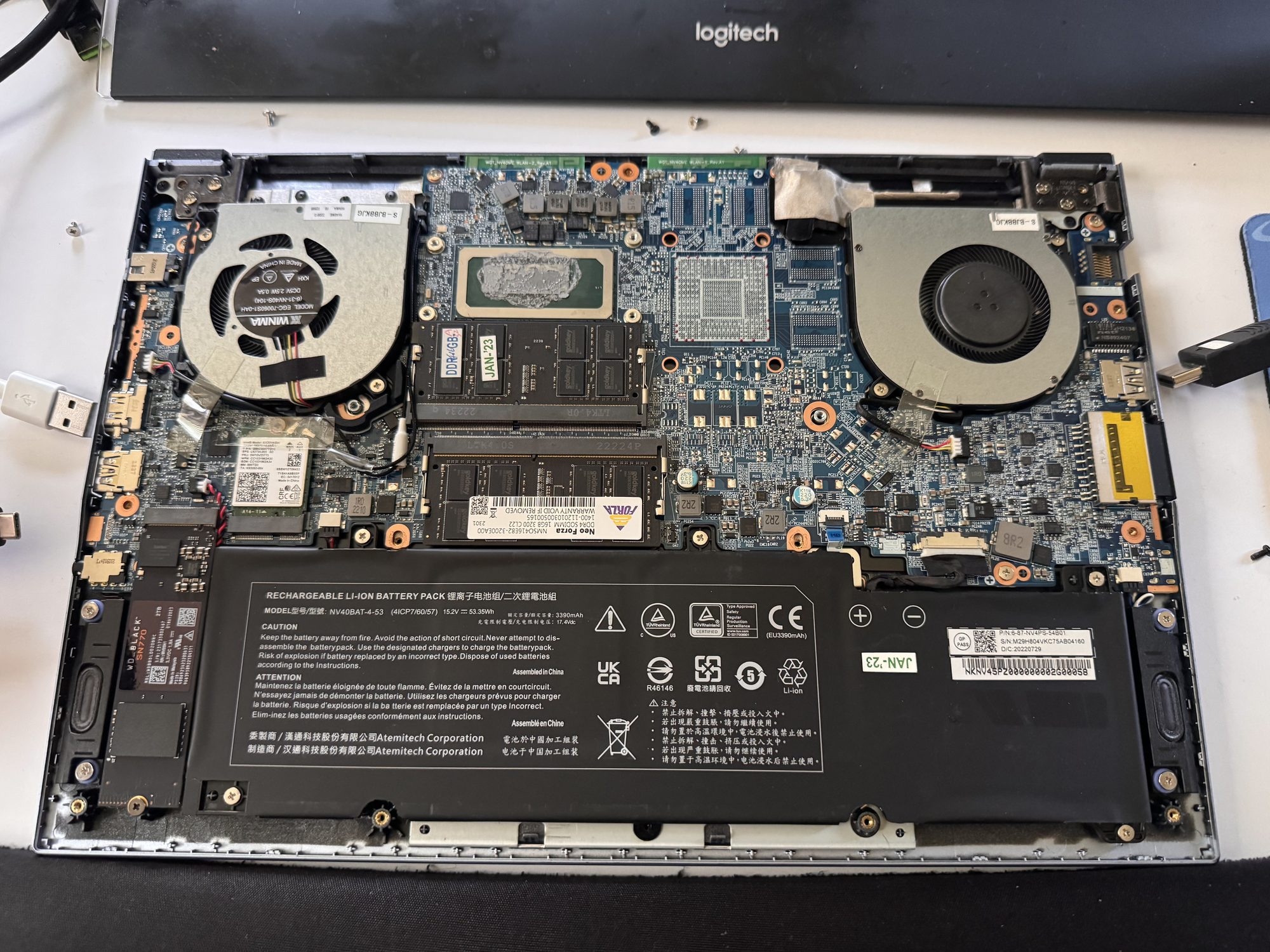 Same motherboard view with the heat sink removed, revealing the CPU die covered in old, dried thermal paste.